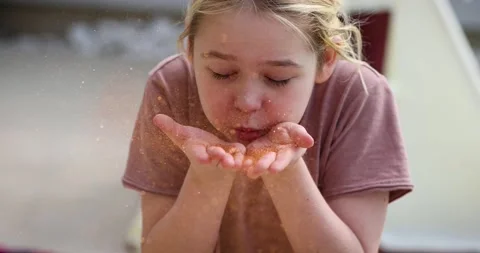 Cute kid, boy blowing glitter sparkles from palms Stock Footage 154418834