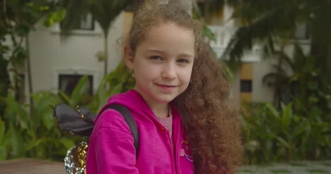 Cute kid child with pretty face on street. Concept of a happy childhood. Funny Video stock 147648458