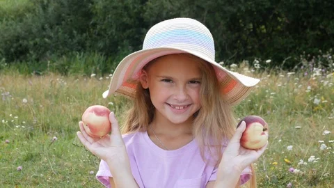Cute kid closes and opens eyes covering them with peaches. Stock Footage 113080471