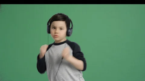 Cute kid dancing with headphones  - Alpha Channel, Green Screen Video stock 129358524