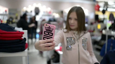 Cute Kid Girl Posing Taking Selfie Shots In New Clothes Store Stock Footage 68935944