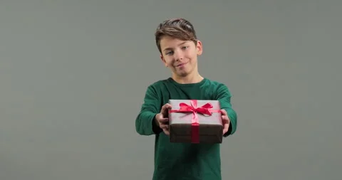 Cute kid gives a present box to camera isolated Stock Footage 286705855