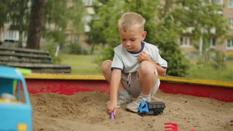 Cute kid having fun on a playground, child entertained in a sandpit. Little.. Stock Footage 341270711