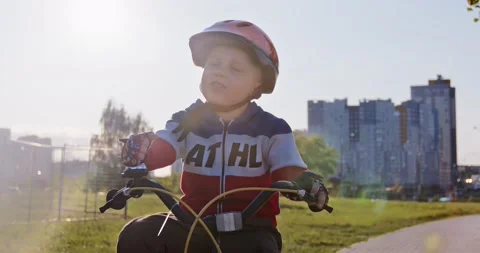 A cute kid in a helmet is riding. Stock Footage 166860747