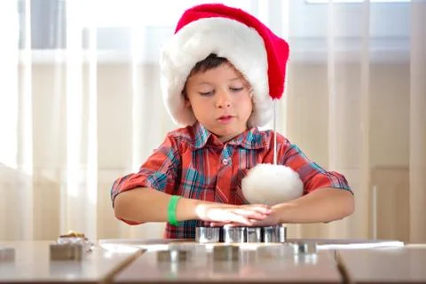 Cute kid helping at kitchen with baking cookies Stock Photos