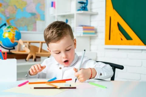 Cute kid at home or daycare. Child studying from home. Elementary school Stock Photos