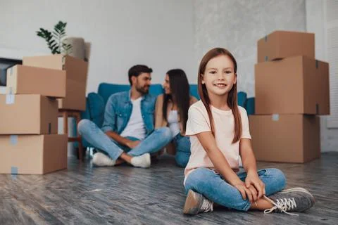 Cute kid looking at the camera while parents talking Stock Photos