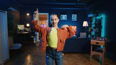 Cute kid pressing record button on filming equipment, doing dance tutorial Fotos Stock