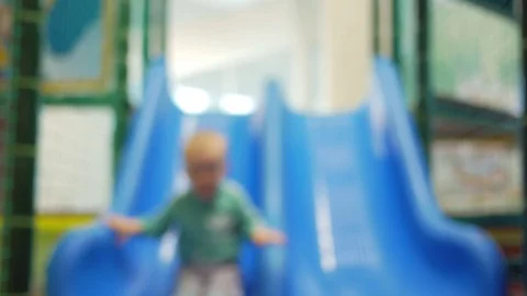A cute kid pulls off the blue roller coaster in an amusement park. Multicolored Stock Footage 75043294