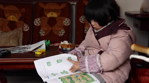 Cute kid reading math book at home Stock Footage 46602943