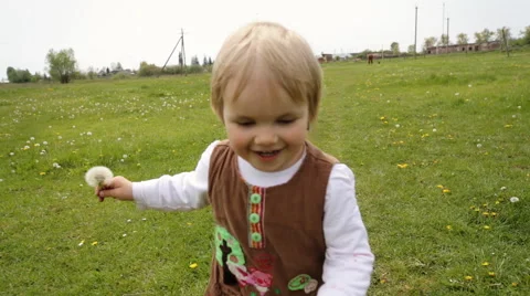 Cute kid running on the grass and falling down Stock Footage 64540226