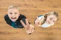 The cute kid show two finger. View from above Photo