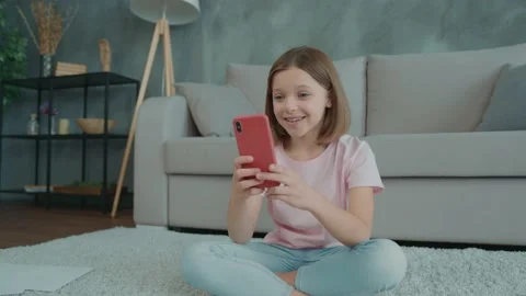 Cute kid sit floor use device read share study text classmates in apartment Video stock 166678575