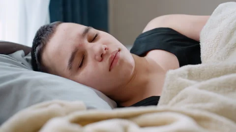 Cute Kid Sleeping Sideways in Black Singlet Covered With Blanket Video stock 321076646