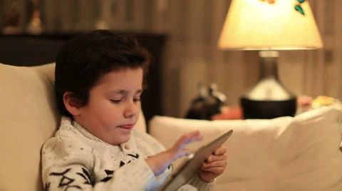 Cute kid using tablet computer Stock Footage 34350353