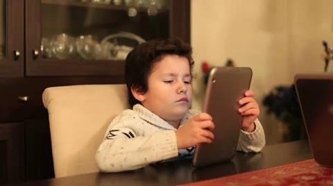 Cute kid using tablet computer Stock Footage 34353536
