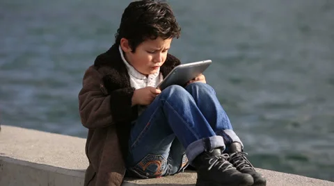 Cute kid using tablet computer Stock Footage 34365619