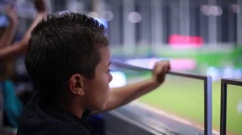 Cute kid watching a game from the stands at stadium Stock Footage 49146672