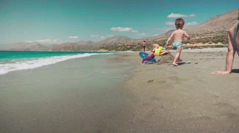 Cute Kids Having Fun on Beach and Playing with Sand Stock Footage 60383238