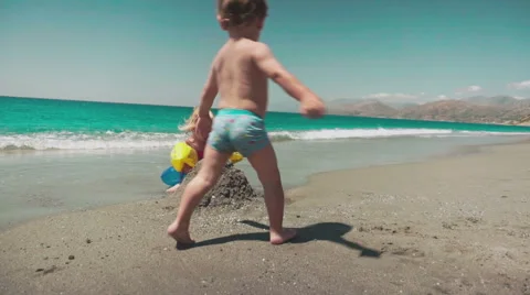 Cute Kids Having Fun on Beach and Playing with Sand Stock Footage 60383440
