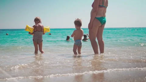 Cute Kids Having Fun on Beach and Playing with Sand 動画素材 60384249