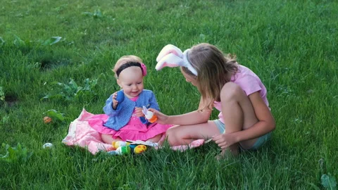 Cute kids playing with easter eggs on grass Vídeo Stock 263486830