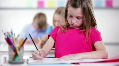 Cute kindergarten girl working at school Stock Footage