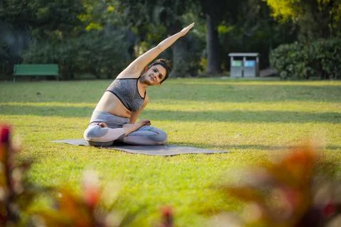 Cute Lady Doing Seated Side Bend Pose, Parsva Sukhasana Stock Photos