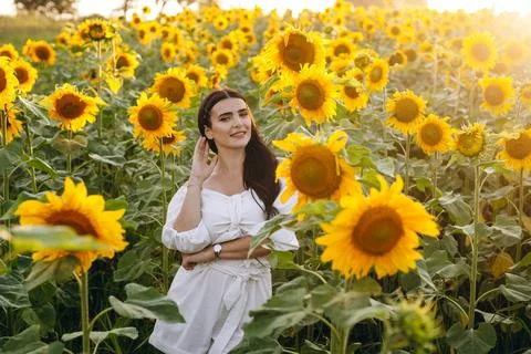 The cute lady is looking at something while posing. Stock Photos