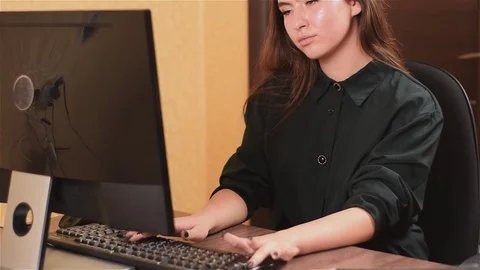 Cute lady working at computer in office. A girl with black nails in a black Video stock 93162087