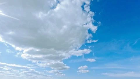 Cute large bright clouds in the blue sky background - photo of nature Stock Photos