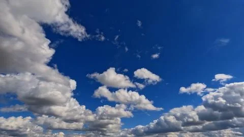 Cute large bright clouds in the blue sky background - photo of nature Stock Photos