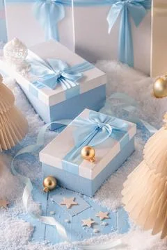 Cute light blue present boxes with snow and decorations. Stock Photos