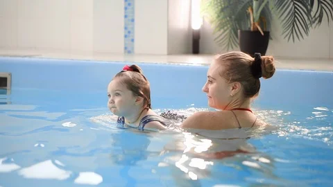 Cute little baby and his mother having swimming lesson in the pool. The Mother 스톡 동영상 101505953