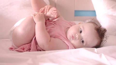 A cute little baby is looking into the camera Video stock 53775475