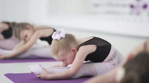 Cute little ballerinas stretching together at dancing school. Adorable little Stock Footage 130989021