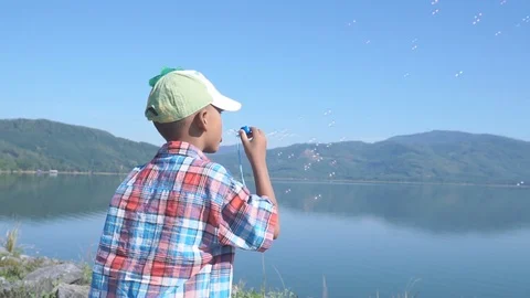 Cute little boy blowing bubble soap Stock Footage 91877692