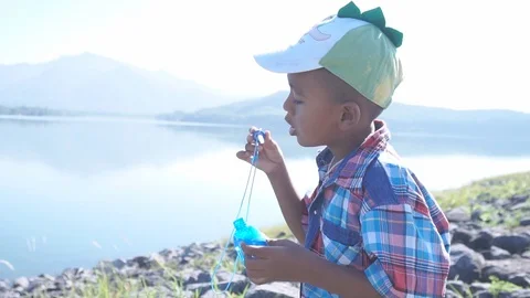 Cute little boy blowing bubble soap Stock Footage 91877720