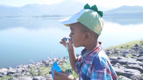 Cute little boy blowing bubble soap Stock Footage 91877785