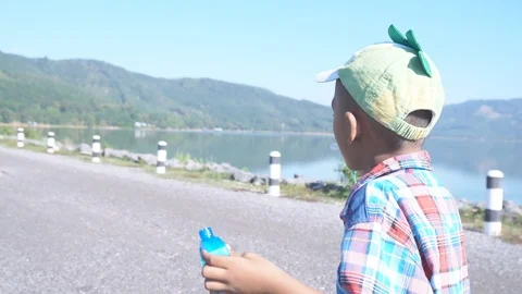 Cute little boy blowing bubble soap Stock Footage 91877801