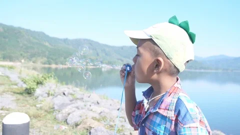 Cute little boy blowing bubble soap Stock Footage 91877852
