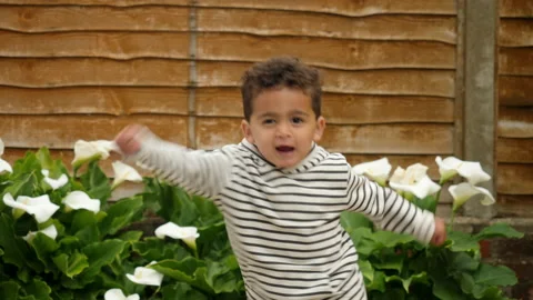A cute little boy dancing and playing outside lifestyle footage Vídeo Stock 131831663
