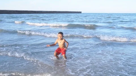 Cute little boy dancing on the beach Stock Footage 91867974