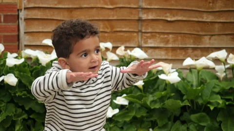 A cute little boy dancing playing outside real lifestyle footage 库存影片 131857248
