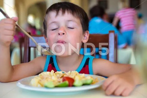 Cute little boy enjoying food Stock Photos
