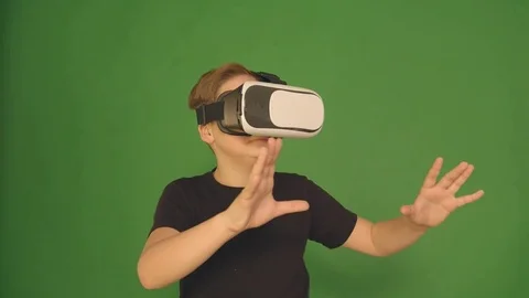 Cute little boy gesturing happily using VR virtual reality 360 degrees glasses Stock Footage 84639120