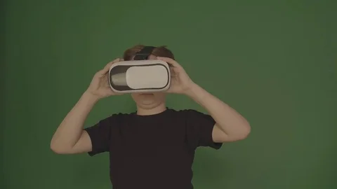 Cute little boy gesturing happily using VR virtual reality 360 degrees glasses 스톡 동영상 84639713