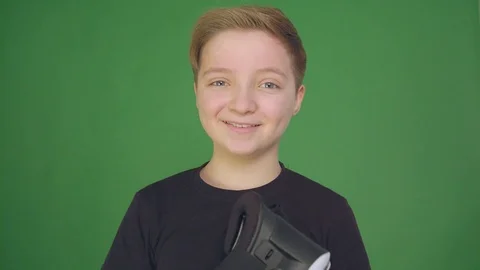 Cute little boy gesturing happily using VR virtual reality 360 degrees glasses Stock Footage 84686783