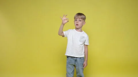 A cute little boy gesturing okay  sign with hands Stock Footage 282108098