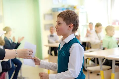 Cute little boy getting module test results in school 写真素材